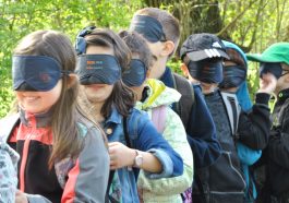 kids all are standing in line and wear a eye mask