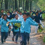 A group of kids running in the meddle of the forest